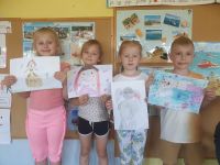 Przedszkolaki z wykonanymi rysunkami